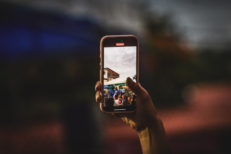 A person taking a picture with a cell phone — Foto por Luciano Oliveira na Unsplash